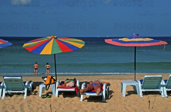 People, umbrellas and sun loungers at Karon Beach, two years in front of the tsunami, Ko Phuket, Thailand, December 2002, vintage, retro, old, historic