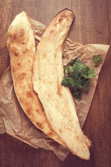 Georgian bread shotis, shotis puri, on a wooden table, top view