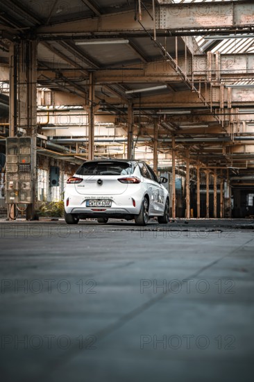 White car parked in empty industrial building, urban industrial look, deer e-car sharing, Motorworld Rüsselsheim, Germany