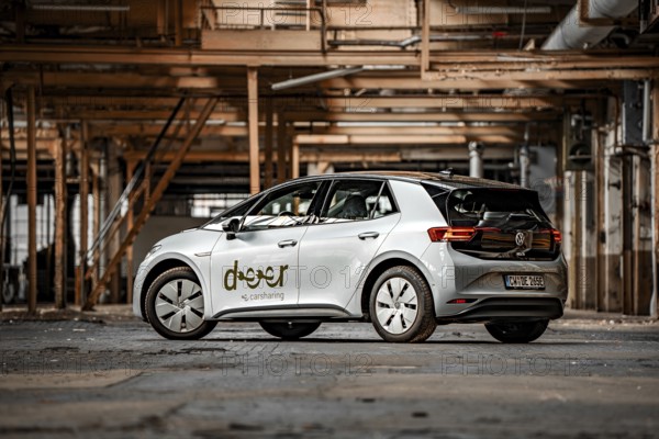 A modern electric car in an industrial environment with metallic structures, Deer E-Car Sharing, Motorworld Rüsselsheim, Germany