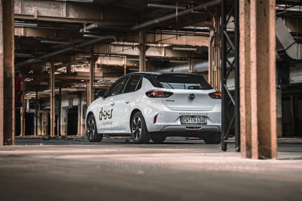 Rear view of a white car sharing car in an urban industrial building, Deer E-Car Sharing, Motorworld Rüsselsheim, Germany