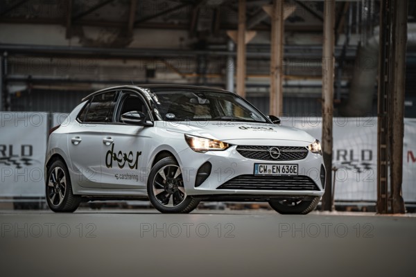 Opel car sharing car in modern factory building, visible from the front, Deer E-Car Sharing, Motorworld Rüsselsheim, Germany