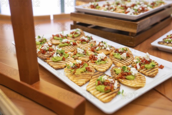 Appetizers with avocado and tomato served appealingly on white plates, Christmas party Dekra Congresshotel Wart, Calw district, Germany