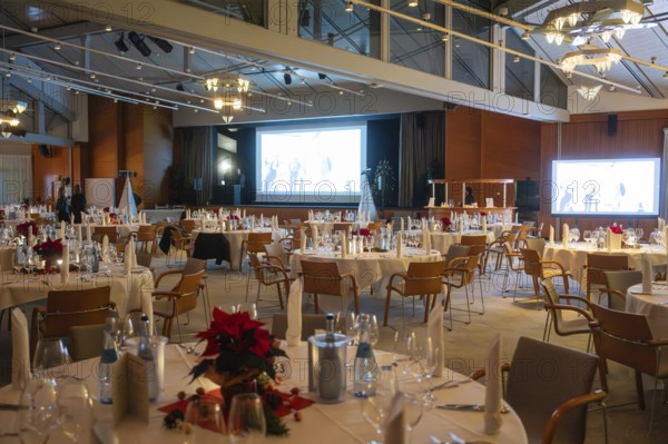 An elegant event room with set round tables and festive lighting, Christmas party Dekra Congresshotel Wart, Calw district, Germany