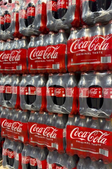 0.5 half liter plastic PET bottles stacked in plastic packs with sugary caffeinated beverage soft drink Coca Cola, Germany