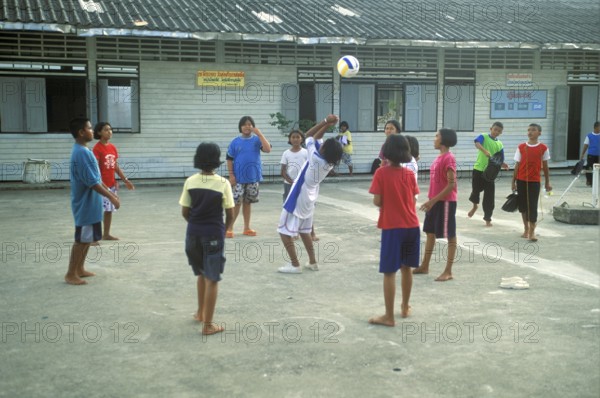 Students in a schoolyard in the stilt village of Ko Pannyi in Phangnga Bay near Ko Phuket, two years in front of the tsunami, Thailand, December 2002, vintage, retro, old, historic