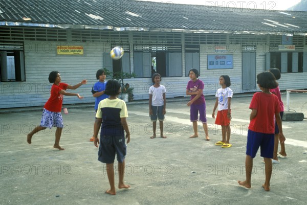 Students in a schoolyard in the stilt village of Ko Pannyi in Phangnga Bay near Ko Phuket, two years in front of the tsunami, Thailand, December 2002, vintage, retro, old, historic