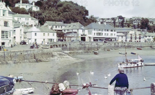 Historic waterfront buildings around the harbour at St Mawes, Cornwall, England, UK c 1960