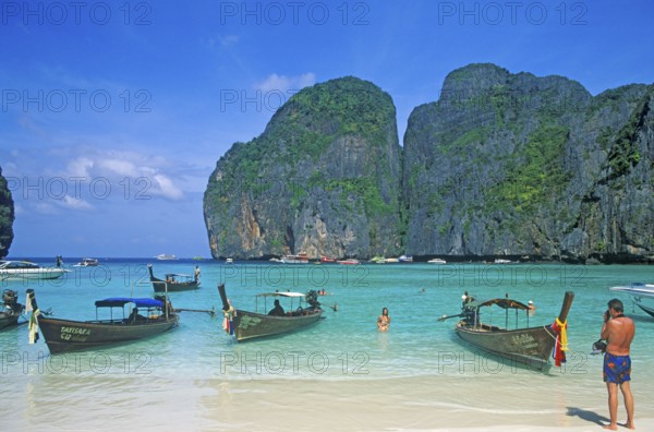 People, longtail boats on Maya Bay beach, known from the movie The Beach, one year in front of the tsunami, Ko Phi Phi Le, Thailand, December 2002, vintage, retro, old, historic