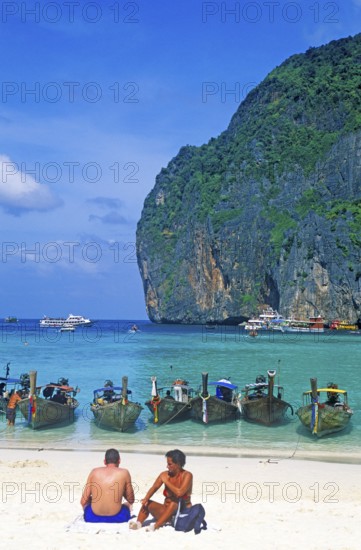 People, longtail boats on Maya Bay beach, known from the movie The Beach, one year in front of the tsunami, Ko Phi Phi Le, Thailand, December 2002, vintage, retro, old, historic