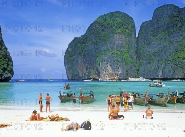 People and longtail boats on Maya Bay beach, known from the movie The Beach, one year in front of the tsunami, Ko Phi Phi Le, Thailand, December 2002, vintage, retro, old, historic