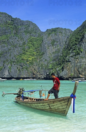 Boatmaster, longtail boat on Maya Bay beach, known for the movie The Beach, one year in front of the tsunami, Ko Phi Phi Le, Thailand, December 2002, vintage, retro, old, historic