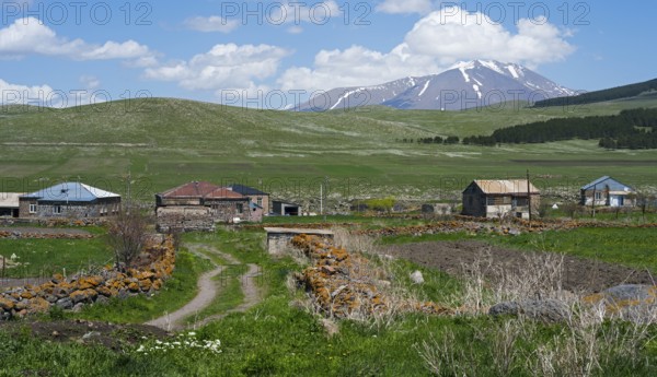 Dirt roads in a village with mountain views and snowy peaks in the distance, Jigrasheni, Didi Abuli mountain, Samtskhe—Javakheti region, Samtske Javacheti, Lesser Caucasus, Georgia