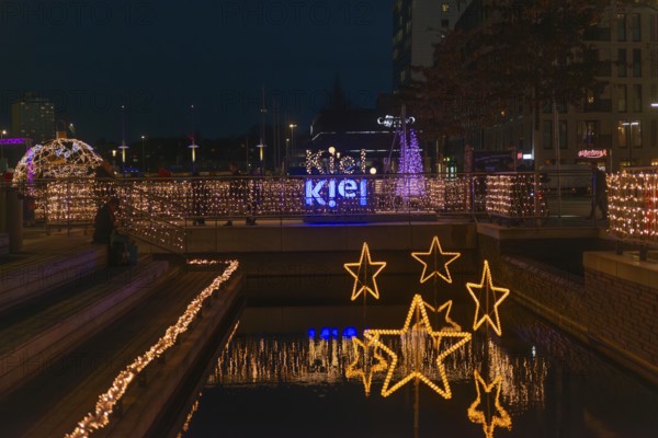 Christmas decoration in Kiel am Holstenfleet, Kleiner Kiel Canal, city center, Christmas, lighting, lights, sailboats, stars, lettering, tree ball, water reflection, bridge, evening, darkness, Germany