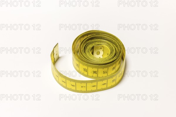 Yellow rolled up tape measure with visible numbers, Germany