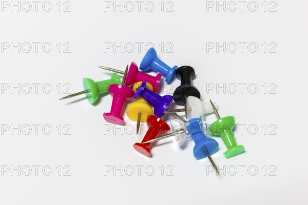 Colorful drawing pins with metal tips on white background, Germany
