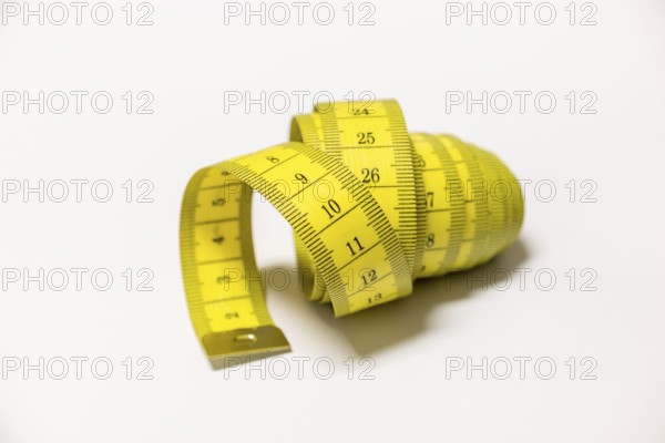 Yellow tape measure rolled into a spiral shape, Germany