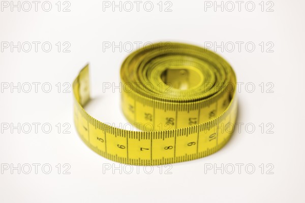 Rolled yellow tape measure that enables accurate measurements, Germany