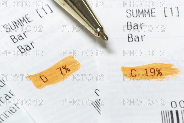Receipts with marked VAT rates and a partially visible pen, Germany