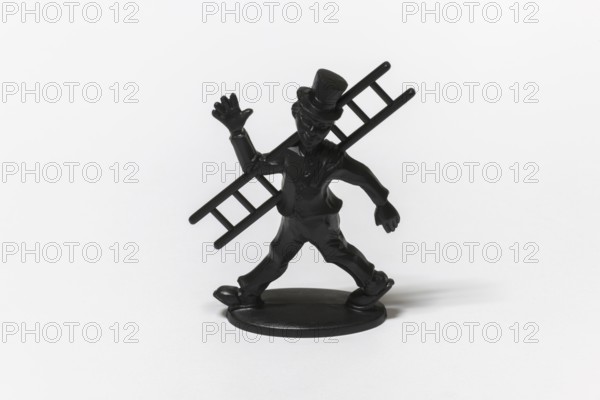 Black figure of a chimney sweep with cylinder and ladder as a lucky charm, Germany