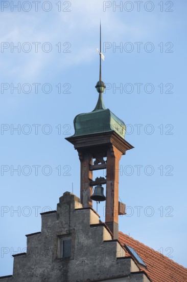 A historic bell tower with bell and weather vane against a clear blue sky, Engelberg near Schorndorf, Baden-Württemberg, Germany
