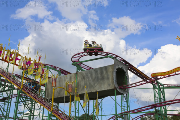 Wilde Maus, little rollercoaster for children, fairground in Friedrichsau Ulm, public festival, hustle and bustle, fair, amusement park, amusement attraction, ride, blue sky, clouds, Ulm, Baden-Württemberg, Germany