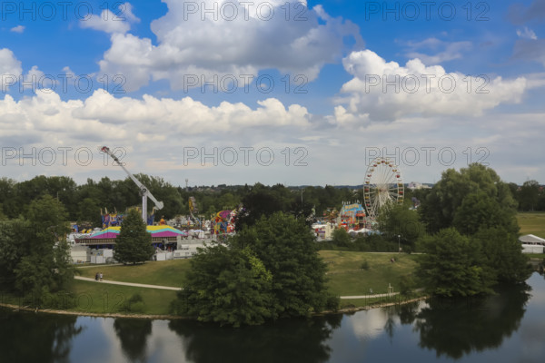 Fairground in Ulm Friedrichsau, folk festival, hustle and bustle, ferris wheel, amusement park, amusement attraction, ride, blue sky, clouds, natural lake, Ausee, Ferris wheel, Ulm, Baden-Württemberg, Germany