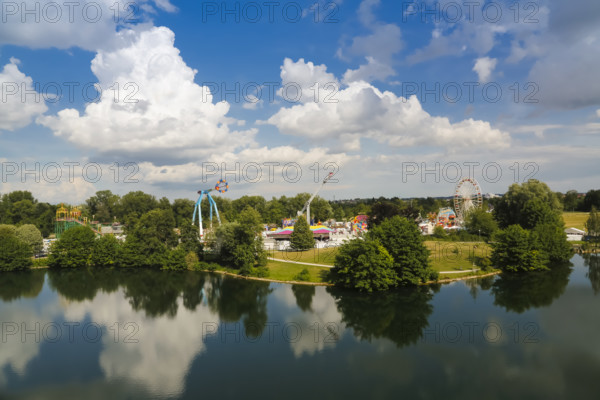 Fairground in Ulm Friedrichsau at night, folk festival, hustle and bustle, fair, amusement park, amusement attraction, ride, blue sky, clouds, natural lake, Ausee, artistico the largest transportable swing in the world, no limit carousel, Ferris wheel, Ulm, Baden-Württemberg, Germany