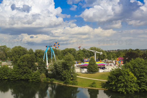Fairground in Ulm Friedrichsau, folk festival, hustle and bustle, amusement park, amusement attraction, ride, blue sky, clouds, natural lake, Ausee, artistico the largest transportable swing in the world, Ulm, Baden-Württemberg, Germany