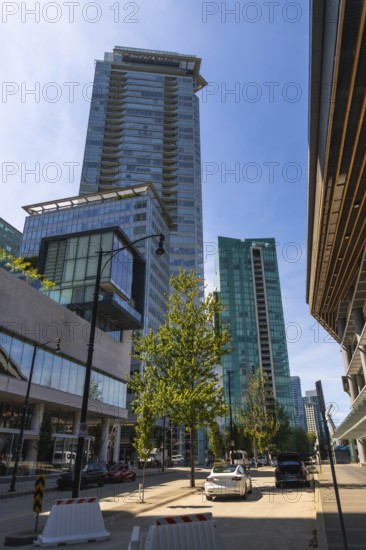 Sunlight illuminating modern skyscrapers and street view in downtown vancouver, british columbia, showcasing urban development and architectural design