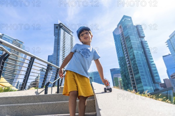 Young child playing joyfully with a toy car on the stairs, soaking up the sun while surrounded by vancouver's stunning modern architecture and vibrant cityscape