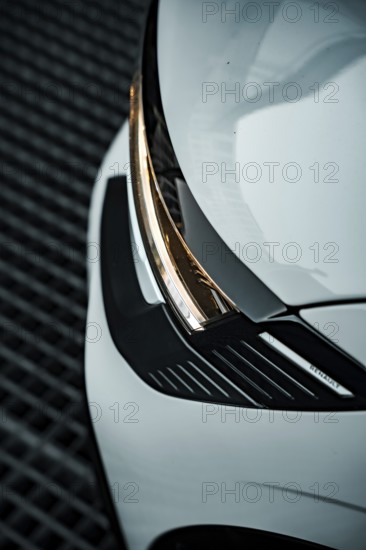 Close-up of a white car focusing on the modern headlight design, Deer E-Carsharing, Renault Megane, Calw, Germany