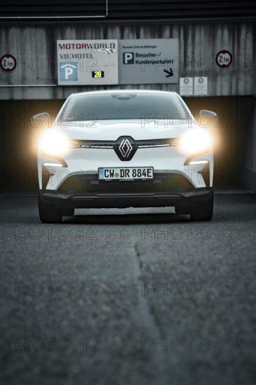 SUV with headlights switched on in front of a parking garage, front view, Deer e-Carsharing, Renault Megane, Calw, Germany