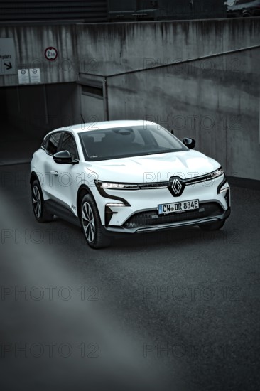 White modern SUV drives out of an underground car park on asphalt ground, Deer E-Carsharing, Renault Megane, Calw, Germany