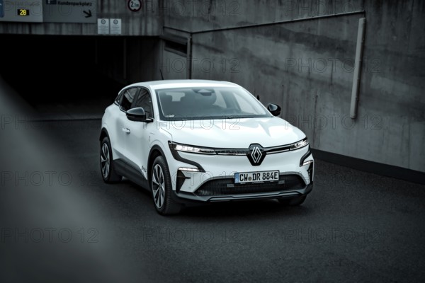 White modern SUV drives out of an underground car park on asphalt ground, Deer E-Carsharing, Renault Megane, Calw, Germany