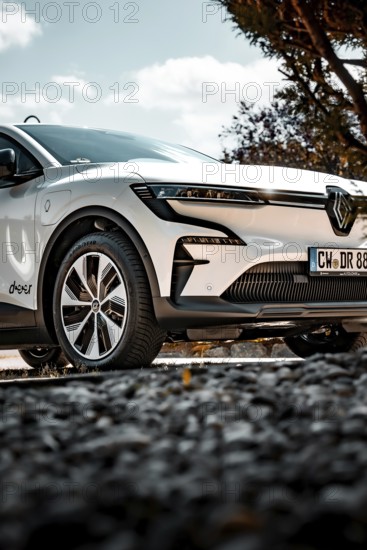 Close-up of a parked white car with modern wheels and clean design, Deer e-Carsharing, Renault Megane, Calw, Germany