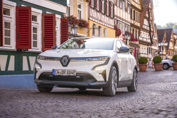 White car in picturesque old town with half-timbered houses and floral decorations, Deer e-Carsharing, Renault Megane, Calw, Germany