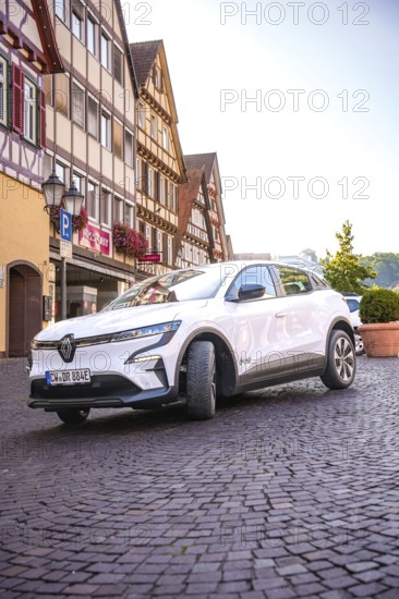 Renault Auto drives down the paved street of a historic town, Deer e-Carsharing, Renault Megane, Calw, Germany