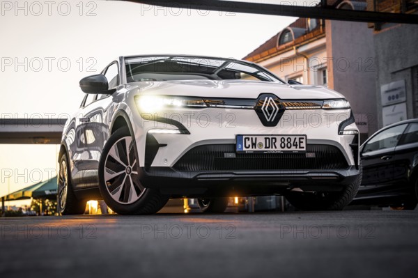 Low angle view of a car on an urban road in front of modern architecture, Deer E-Carsharing, Renault Megane, Calw, Germany