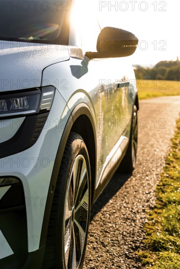 A modern car shines in sunlight driving across a country road, Deer E-Carsharing, Renault Megane, Calw, Germany