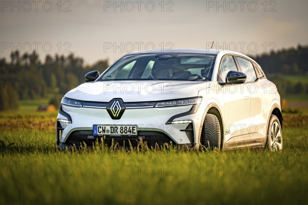 White modern car in a vast green landscape, Deer e-Carsharing, Renault Megane, Calw, Germany