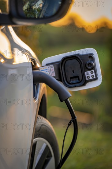 Car is charged at sunset at a charging station for electric cars, Deer E-Carsharing, Renault Megane, Calw, Germany