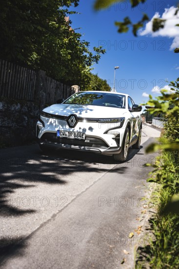White car driving down the street on a sunny summer day, Deer e-Carsharing, Renault Megane, Calw, Germany