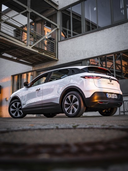 Modern car parked in front of a building in the warm evening light, Deer E-Carsharing, Renault Megane, Calw, Germany