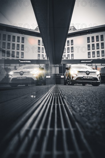 Car reflected in a modern building at gray dusk, Deer E-Carsharing, Renault Megane, Calw, Germany
