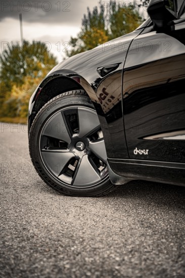 Detailed view of a car tire on a grey road surface, Deer e-car sharing, Tesla Model 3, Calw, Germany
