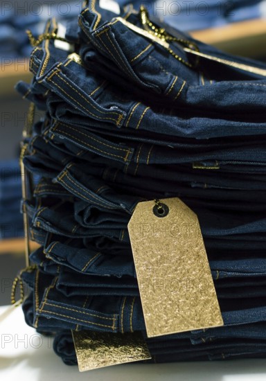 Close up of blue jeans on others with copy space, Various jeans on others with space for text, Clothes sale concept
