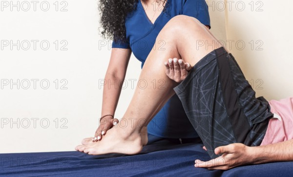 Leg rehabilitation physiotherapy. Knee and knee rehabilitation physiotherapy. Orthopedic specialist helping a patient with a leg injury. physiotherapy treatment concept