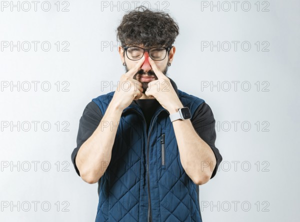 Man with rhinitis touching nose. Person with sinus pain touching nose isolated