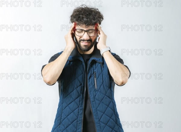 Unhappy person with a headache and isolated migraine isolated. Man with a severe migraine holding head